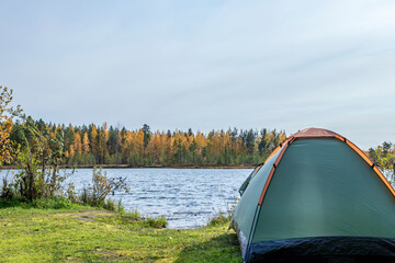 Tourism. Tent by the lake. Autumn landscape.