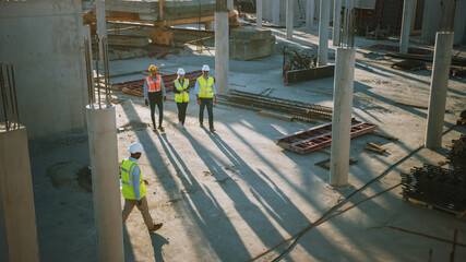 Diverse Team of Specialists Taking a Walk Through Construction Site. Real Estate Building Project...