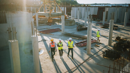 Diverse Team of Specialists Taking a Walk Through Construction Site. Real Estate Building Project...