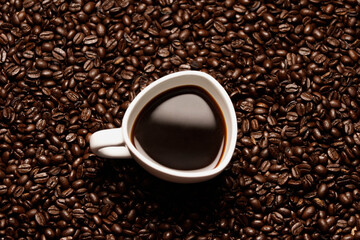 Close-up of a coffee cup with coffee beans 