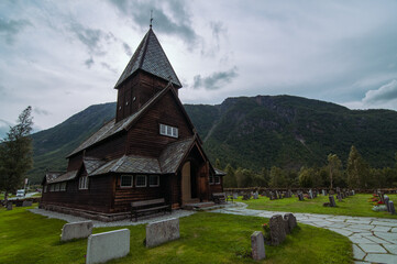 Fototapeta na wymiar wooden røldal stave church in the summer time during cloudy day. Rølda, Norway