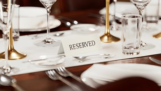 Reserved table card closeup. Animation of elegant tableware at a restaurant.