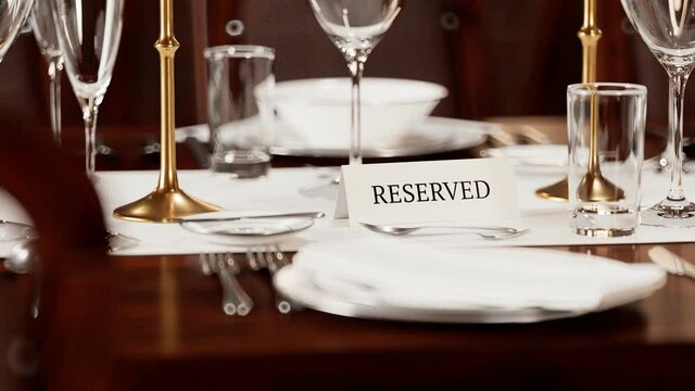 Reserved table card closeup. Animation of elegant tableware at a restaurant.