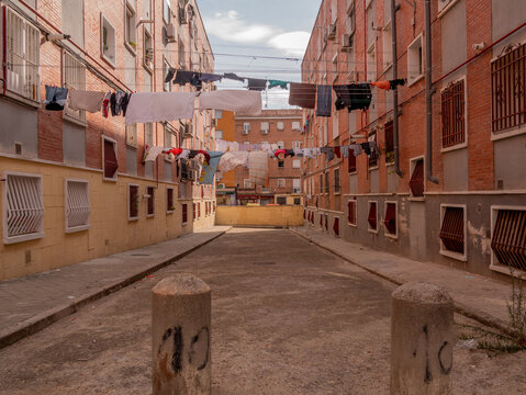 POOR NEIGHBORHOOD STREET WITH LAYING CLOTHES AND GARBAGE