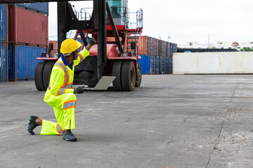 Foreman is giving a signal to work in the harbor. To move the cargo container onto the ship.