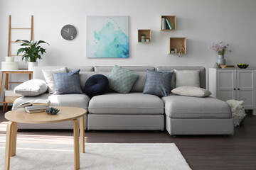 Fototapeta na wymiar Elegant living room with comfortable sofa and wooden table. Interior design