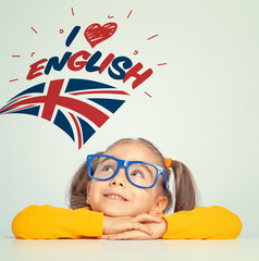 little girl looking at  i love english text and UK flag above her head