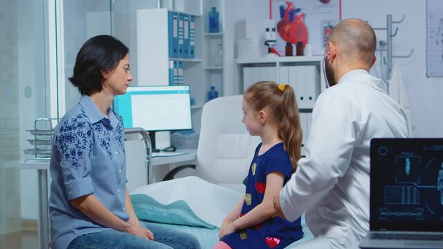 Physician examining lungs using stethoscope, listening child breath. Healthcare practitioner doctor specialist in medicine providing health care services consultation examination treatment in hospital