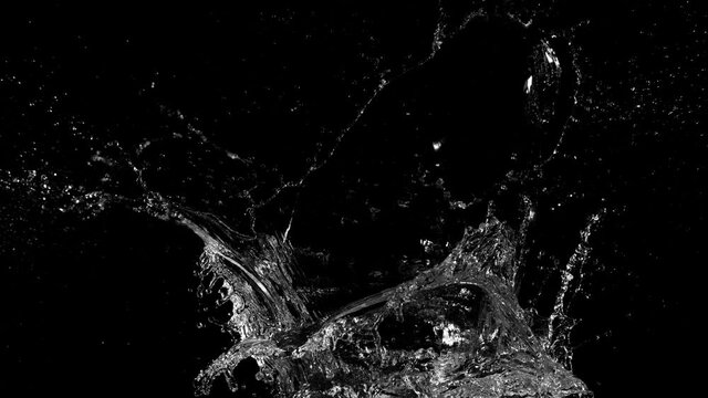 Super slow motion of splashing water crown shape on black background. Filmed on high speed cinema camera, 1000fps.