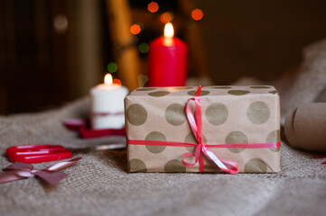 Christmas background with gift boxes, balls of rope, paper rolls and decorations on red. Preparing gifts for Christmas.