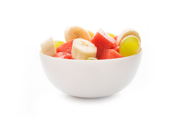 Fresh fruit salad on a plate, isolated on a white background, close-up
