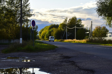 the last rays of the sun at sunset illuminate the road in the village