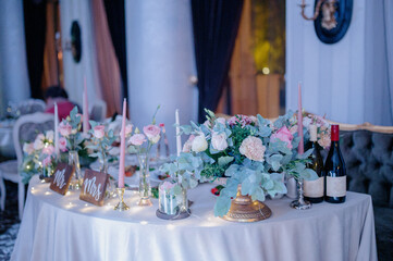 Wedding table decoration with flowers.Decoration of the banquet hall on the wedding day.Wedding table serving. Wedding banquet. Beautiful festive table decorated with bouquet of flowers,