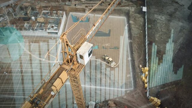 Yellow crane in construction site with statistical graphics animation for production trend and control of workers team. Potential investiment income calculator. Aerial drone footage