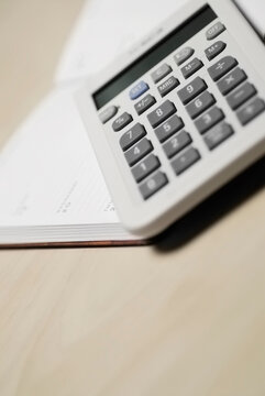 Close-up of a calculator on a diary