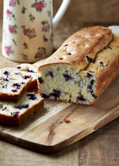 Simple Cake with Bilberries on wooden background.	