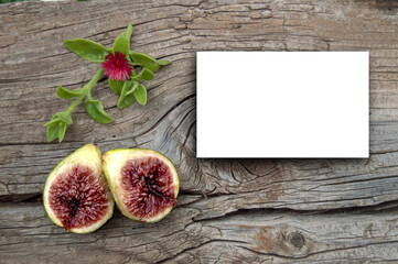 Card on wooden background and fruits for text or images