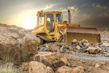 Obraz premium Excavator moving rocks on a road construction site