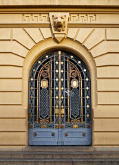 Ancient metallic door on yellow facade, Belo Horizonte, Brazil