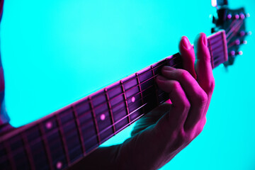 Close up of guitarist hand playing guitar, macro. Concept of advertising, hobby, music, festival,...