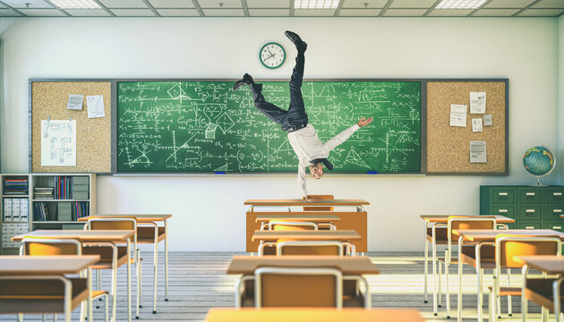 Upside-down teacher balancing on a desk