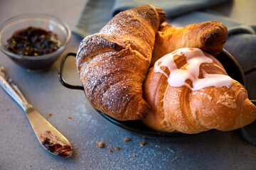 Fresh baked sweet croissants with jam or honey for breakfast