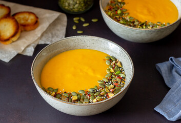 Pumpkin cream soup with seeds, pistachios, sesame seeds and spices. Healthy eating. Vegetarian food.