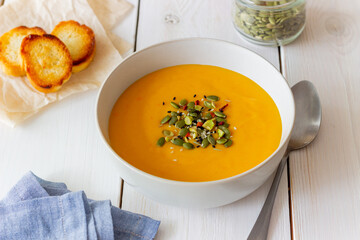 Pumpkin cream soup with seeds, pistachios, sesame seeds and spices. Healthy eating. Vegetarian food.