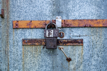 Old door with an old lock. Old padlock.