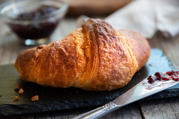Fresh baked sweet croissants with jam or honey for breakfast