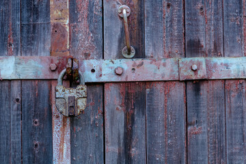Old door with an old lock. Old padlock.