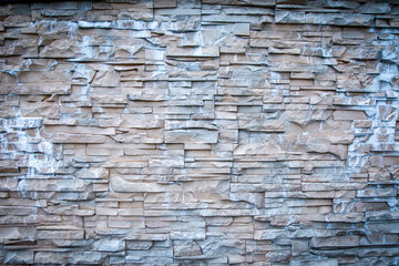 Rough texture of rock wall, The wall has a specific stone pattern.