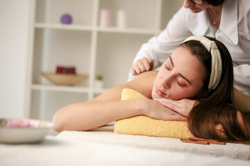 Obraz na płótnie Canvas Massage and body care. Spa body massage. Woman having massage in spa.
