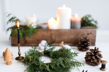 Obraz na płótnie Canvas Making simple stylish christmas wreath with cedar branches, holiday advent