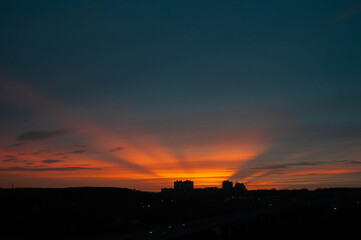 Sunset over the city landscape, the sky is orange-blue