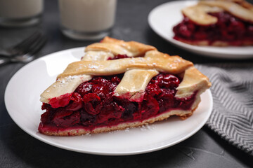 Slice of delicious fresh cherry pie on table, closeup
