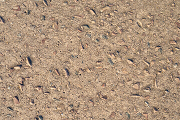 Rocks and concrete. Brown background and cement and pebbles. The old building slab. Brown construction texture.