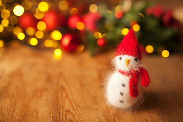 Cute knitted snowman on christmas background