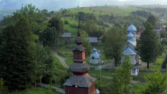 Aerial view of old wooden church in Pylypets, Carpathian village, Ukraine