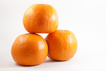 Image of three fresh oranges taken on a white isolated background