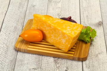 Marble cheese  triangle over wooden