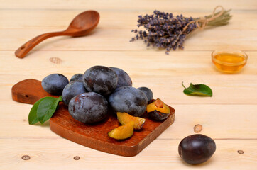 pieces of plums on a wooden cutting board in the kitchen