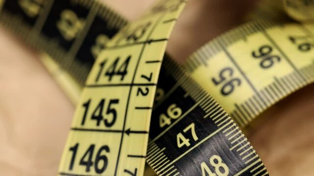 Yellow measuring tape. Macro shot. 