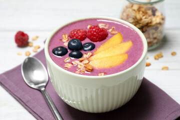 Delicious acai smoothie with fruits served on white wooden table, closeup