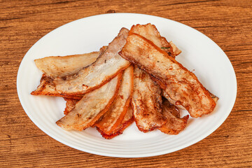 Roasted juicy bacon in the plate
