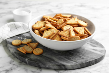 Delicious crispy crackers on white marble table
