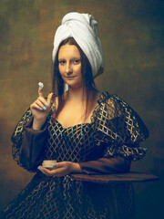Beauty routine. Young woman as Mona Lisa, La Gioconda isolated on dark green background. Retro style, comparison of eras concept. Beautiful female model like classic historical character, old