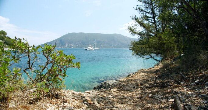 Beautiful landscape with green forest and emerald water lagoon of Foki Fiskardo beach, Kefalonia, Ionian islands, Greece.
