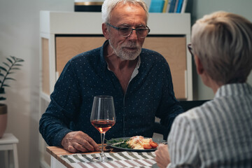 Cheerful couple have romantic dinner at home stock photo