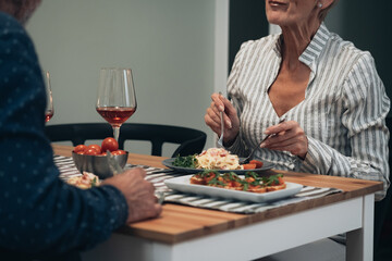 Cheerful couple have romantic dinner at home stock photo